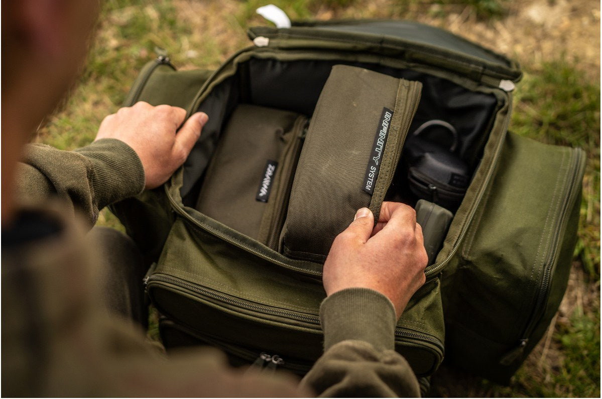 Раница DAIWA BLACK WIDOW COMPACT RUCKSACK open with storage compartments visible.