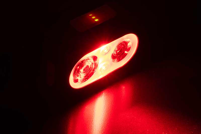 Челник FOX Halo Multi Colour 500C Headtorch CEI227 with bright red LED lights in a dark setting.