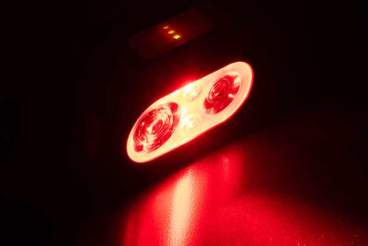 Челник FOX Halo Multi Colour 500C Headtorch CEI227 with bright red LED lights in a dark setting.