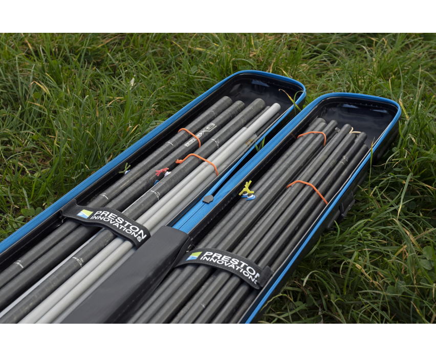 Твърд калъф PRESTON HARDCASE COMPACT KIT SAFE with fishing rods organized neatly in a grass field.