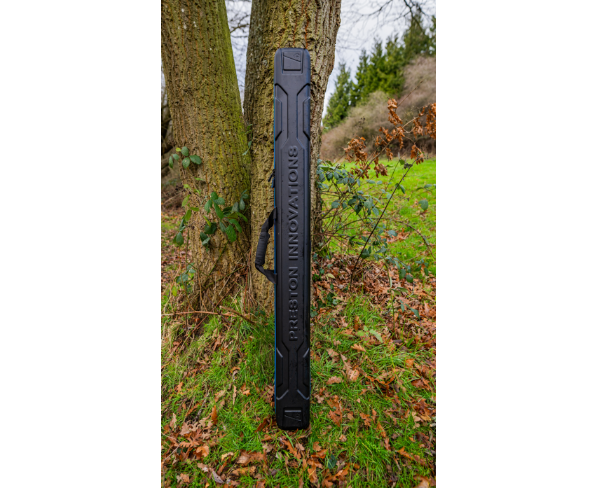 Твърд калъф PRESTON HARDCASE COMPACT KIT SAFE leaning against a tree in a green outdoor setting.