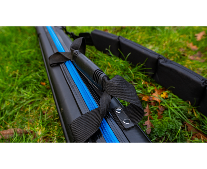 Твърд калъф PRESTON HARDCASE COMPACT KIT SAFE with blue stripes on a grass background.