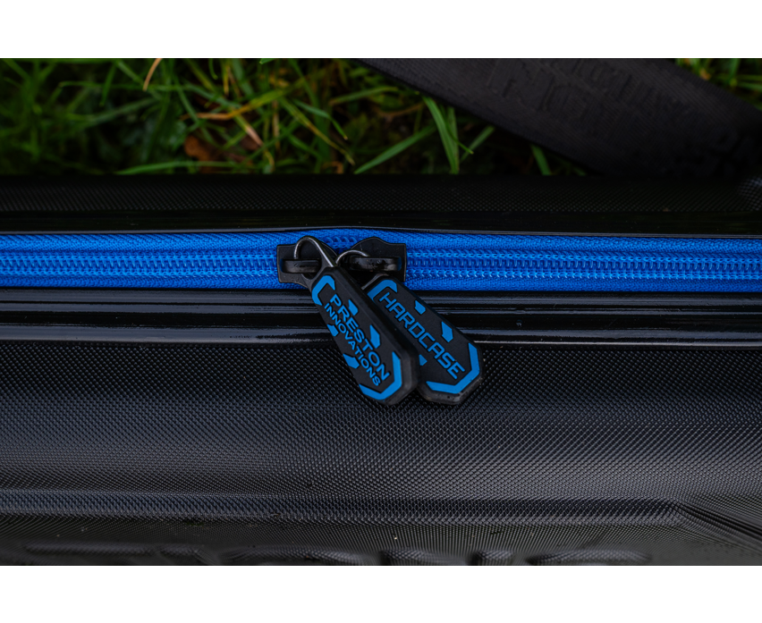 Твърд калъф PRESTON HARDCASE COMPACT KIT SAFE with zippers and blue detailing on a black background.