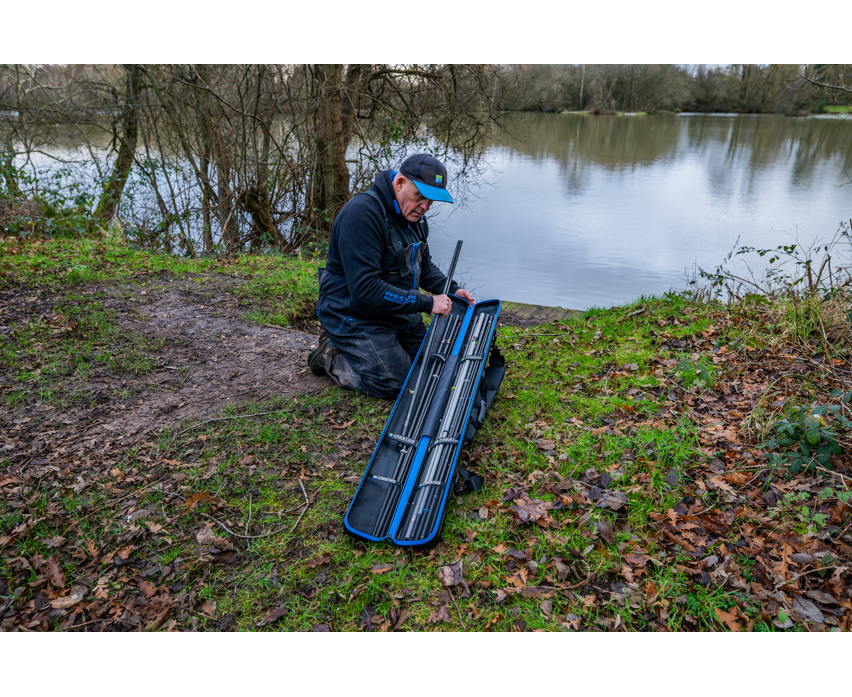 Твърд калъф PRESTON HARDCASE COMPACT KIT SAFE being used by a fisherman by the riverbank.
