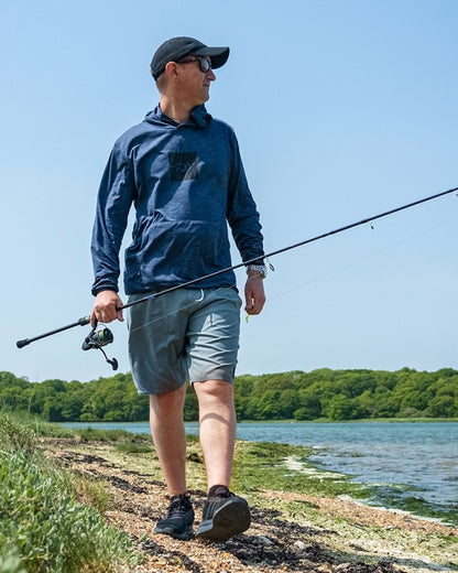 Мъж в тъмен суичър DAIWA LIMITED EDITION SUN PROTECT HOODIE, риболов в природата.