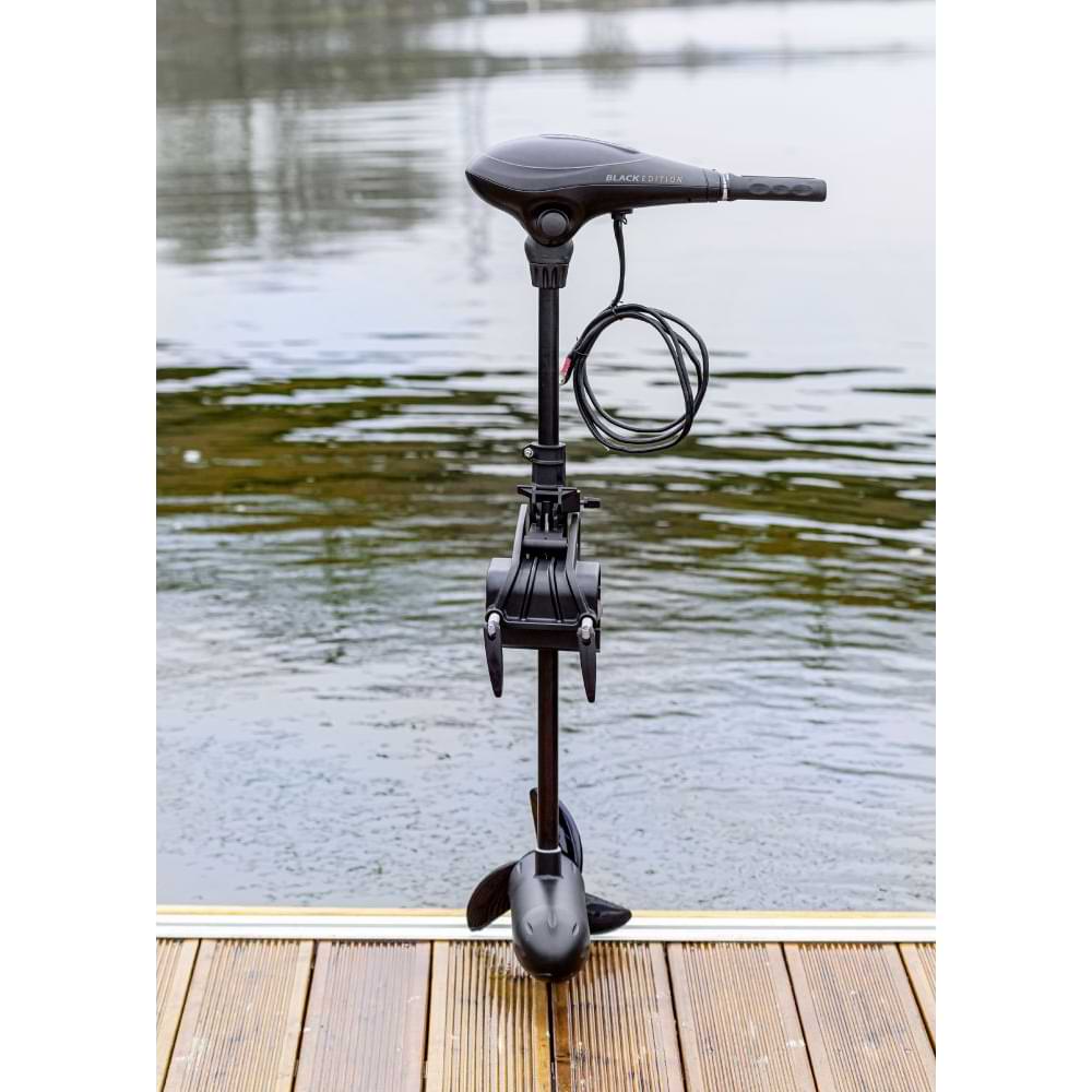 Електрически двигател RHINO BE55 BLACK EDITION ELECTRIC OUTBOARD MOTOR standing on a dock by the water.